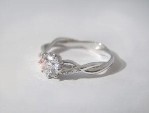 Twisted platinum band with central created diamond and small diamonds