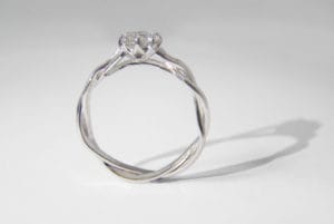 Twisted platinum band with central created diamond and small diamonds