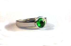 Recycled platinum and tsavorite garnet engagement ring