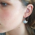 Art Deco silver earrings on model