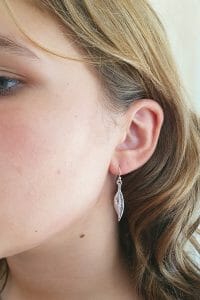 Silver leaf earrings on model
