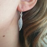 Silver leaf earrings on model