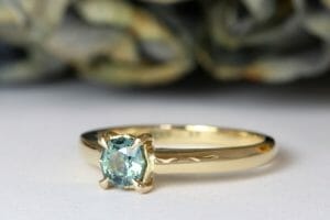 teal sapphire yellow gold