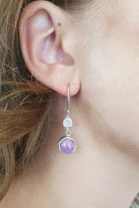 Ruby sapphire earrings on model