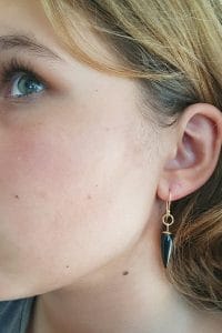 yellow gold onyx earrings on model