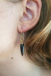 yellow gold onyx earrings on model