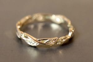 18ct yellow gold wedding band with leaf engraving.