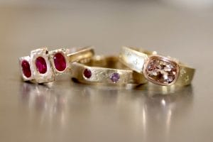 Yellow gold rings with rubies, diamonds, morganites and sapphires.