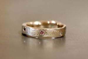 Yellow gold with sapphires, diamonds and garnets.