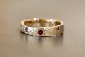 Yellow gold with sapphires, diamonds and garnets.