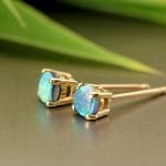 Yellow gold studs with black opals.