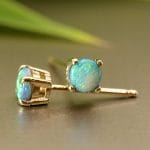 Yellow gold studs with black opals.