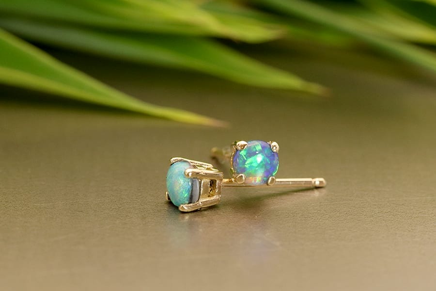 Yellow gold studs with black opals.